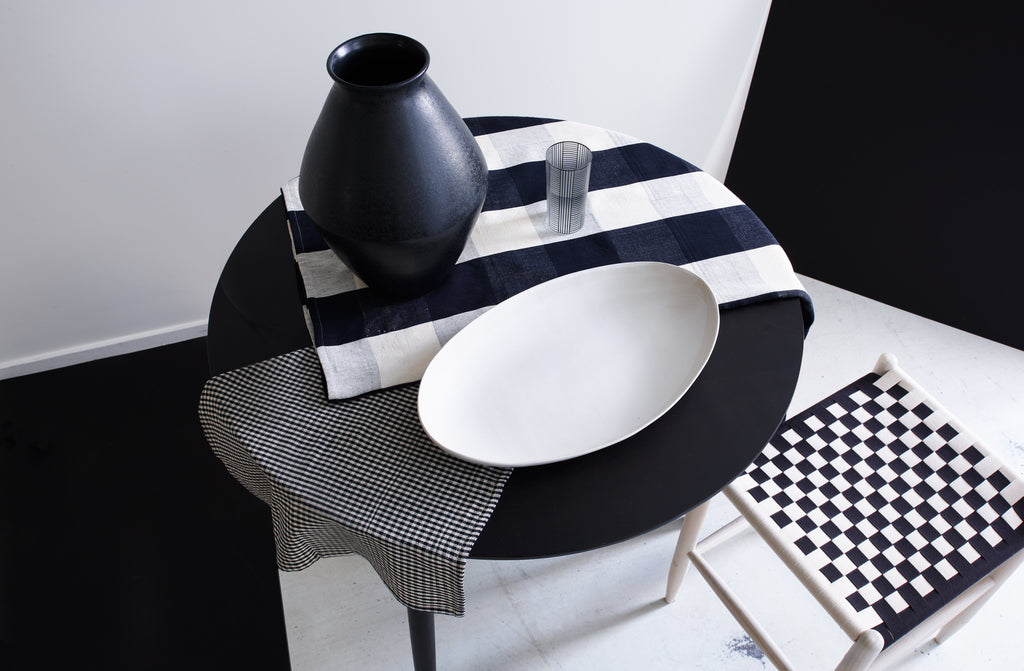 https://marchsf.com/cdn/shop/products/Black-and-white-checkerboard-layered-textiles-and-furniture_PC_5903894a-32d4-458e-8012-3bc1b38e376b_1024x.jpg?v=1636593901