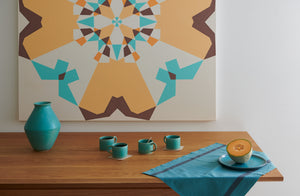Christiane-Perrochon-Turquoise-Mugs-and-Vase-with-turquoise-charvet-kitchen-towel-and-Leslie-Wilkes-Painting-as-background