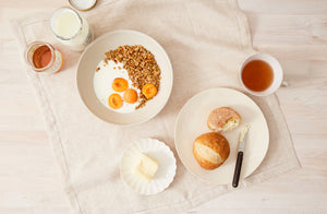 Christiane-perrochon-sand-and-white-dinnerware-breakfast-setting-with-yogurt-fruit-and-tea