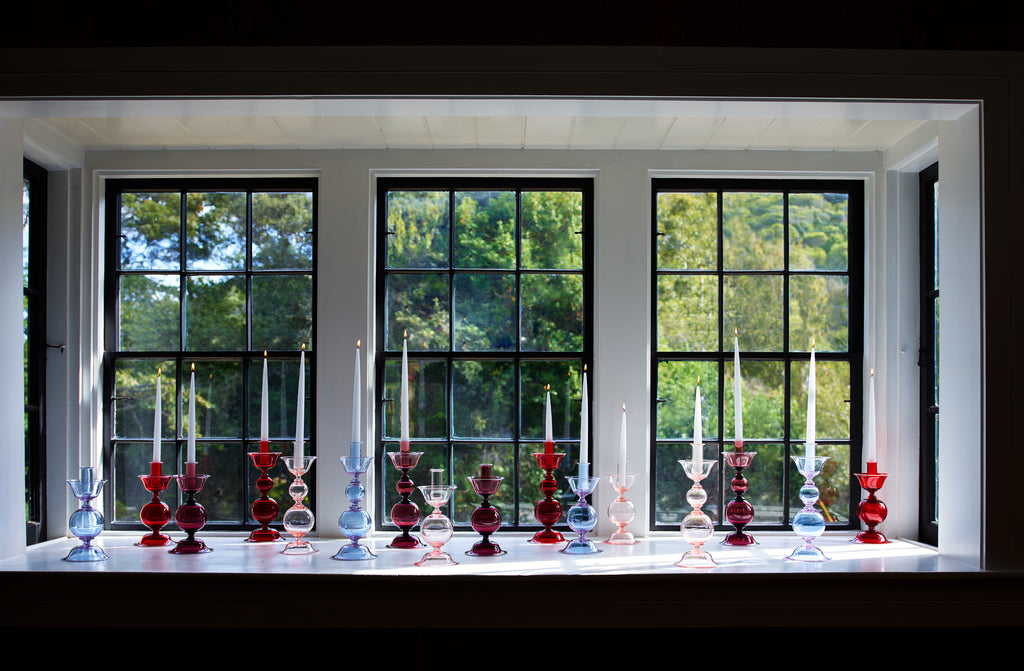 David-Fuin-murano-multi-colored-Candlesticks-Lit-in-Window-march