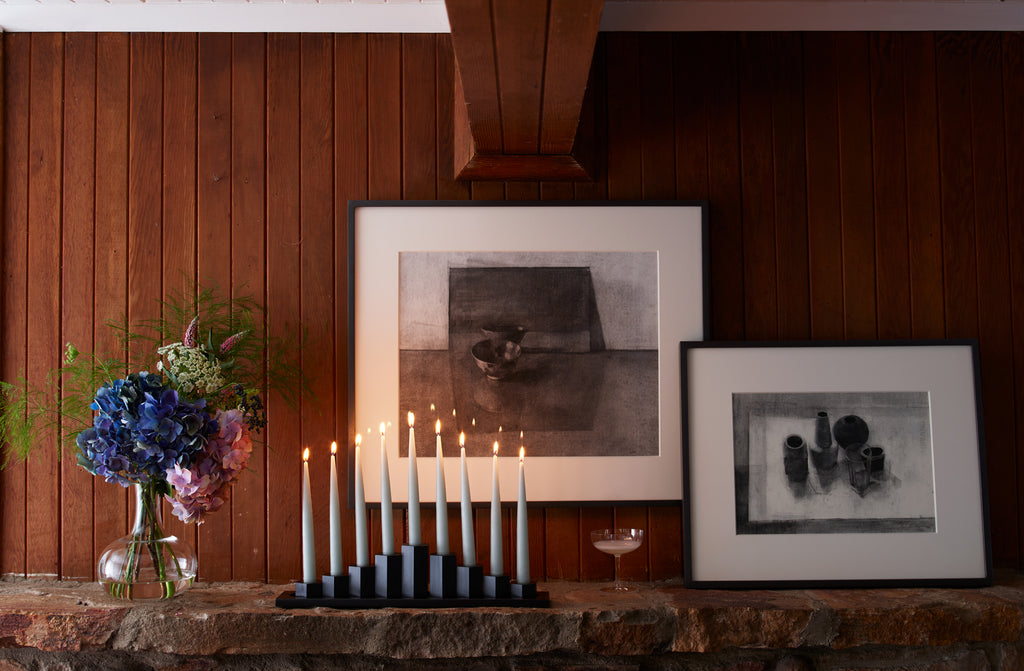 MARCH-Black-Steel-Menorah-on-Mantle-with-champagne-glass-and-Jason-Line-framed-drawings