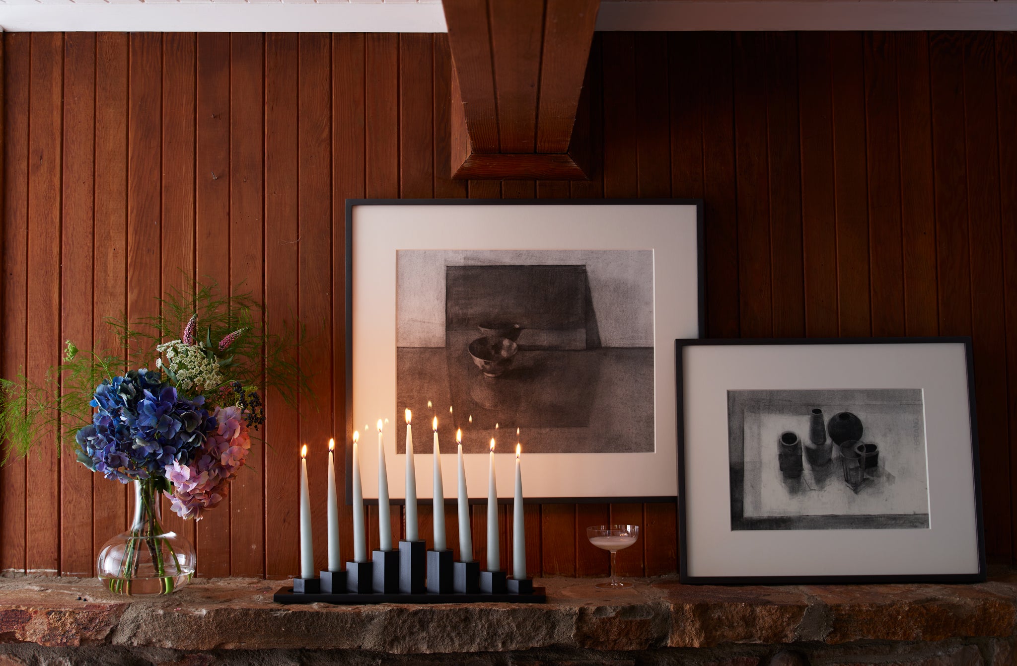 MARCH-Black-Steel-Menorah-on-Mantle-with-champagne-glass-and-Jason-Line-framed-drawings
