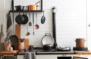 march-black-steel-pot-rack-with-pots-and-hanging-tools-above-aga-stove