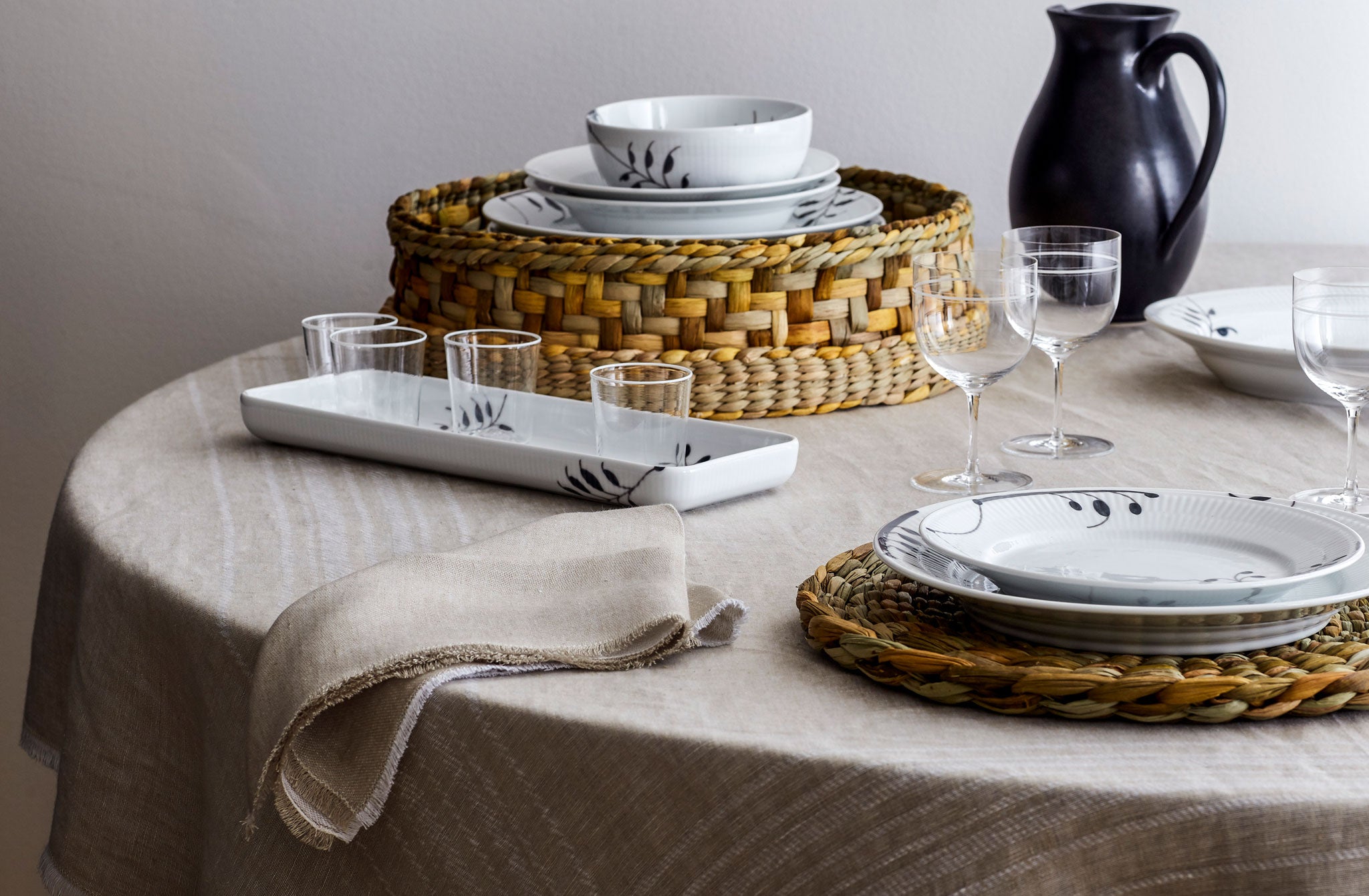 Royal Copenhagen Black Fluted Mega Collection with Rush Matters Accessories and Christiane Perrochon pitcher on tabletop. Default