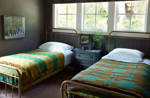 R P Miller blankets on twin metal beds in room with Jason Line painting and Christiane Perrochon mugs. Default