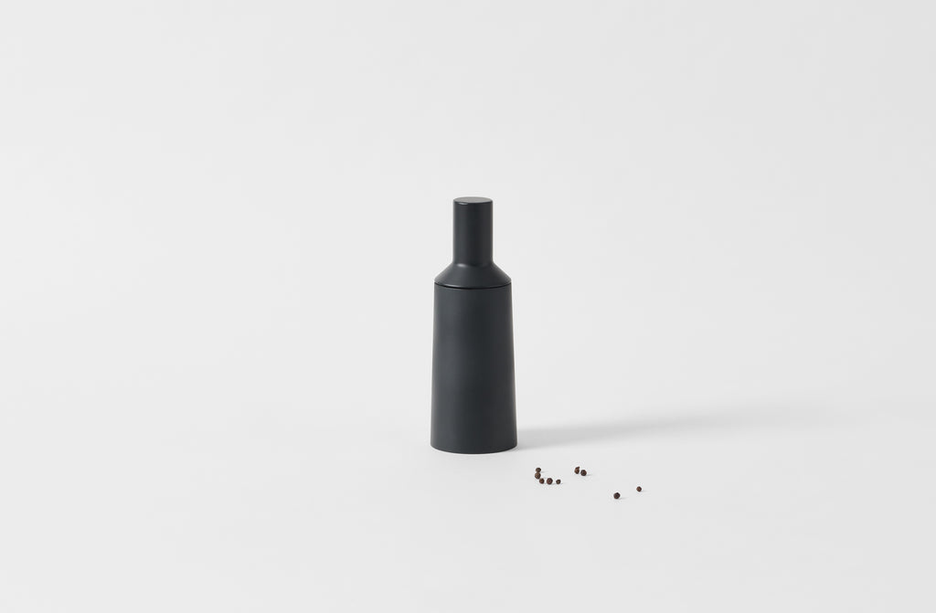 alpi black mill with peppercorns to one side