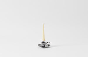 black and white splatterware candleholder with taper candle