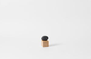 carol leskanic black gesso handheld sculpture on a natural wood base
