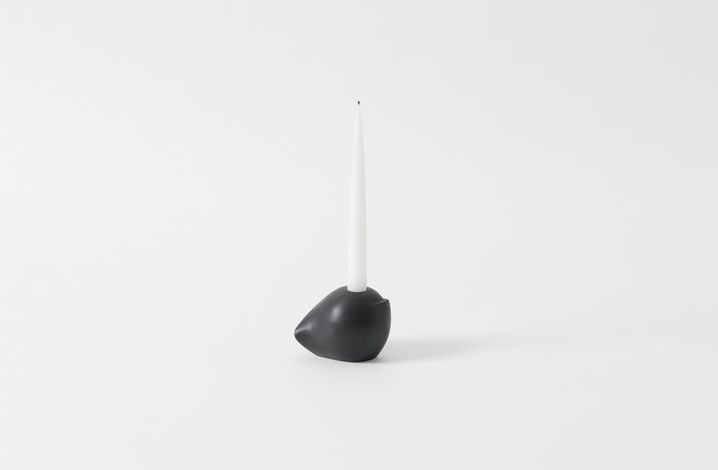 carol leskanic black gesso short sculptural candlestick with a white taper candle