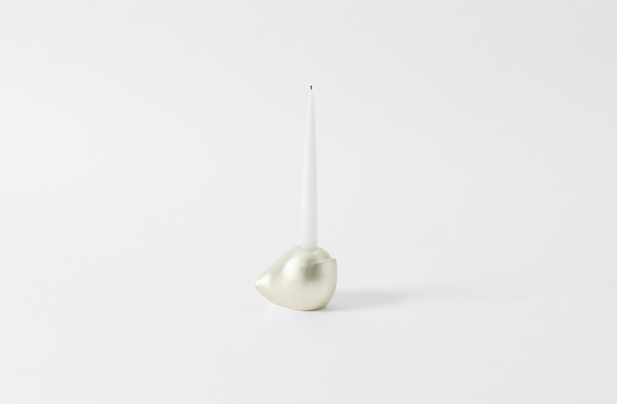 carol leskanic white gold short sculptural candlestick with white taper candle