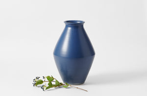 christiane perrochon indigo large vase with a branch with dark indigo berries set to one side