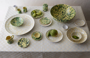 cream-and-white-splatterware-with-green-on-cream-stacked-on-cream-check-tablecloth_p