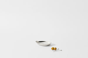 georg jensen sky steel cocktail sticks shown with olives on one stick next to bowl that is part of a set