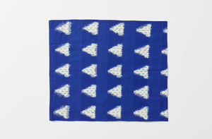 one gregory parkinson indigo sky napkin unfolded showing the complete indigo and cream repeat pattern