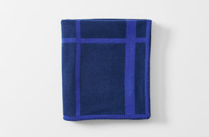 cashmere and wool throw blanket inspired by le corbusier lc2 in dark navy and purple shown folded