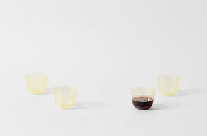 four lobmeyr viennese lace engraved yellow alpha tumblers one shown with red wine to display the pattern of the engraving