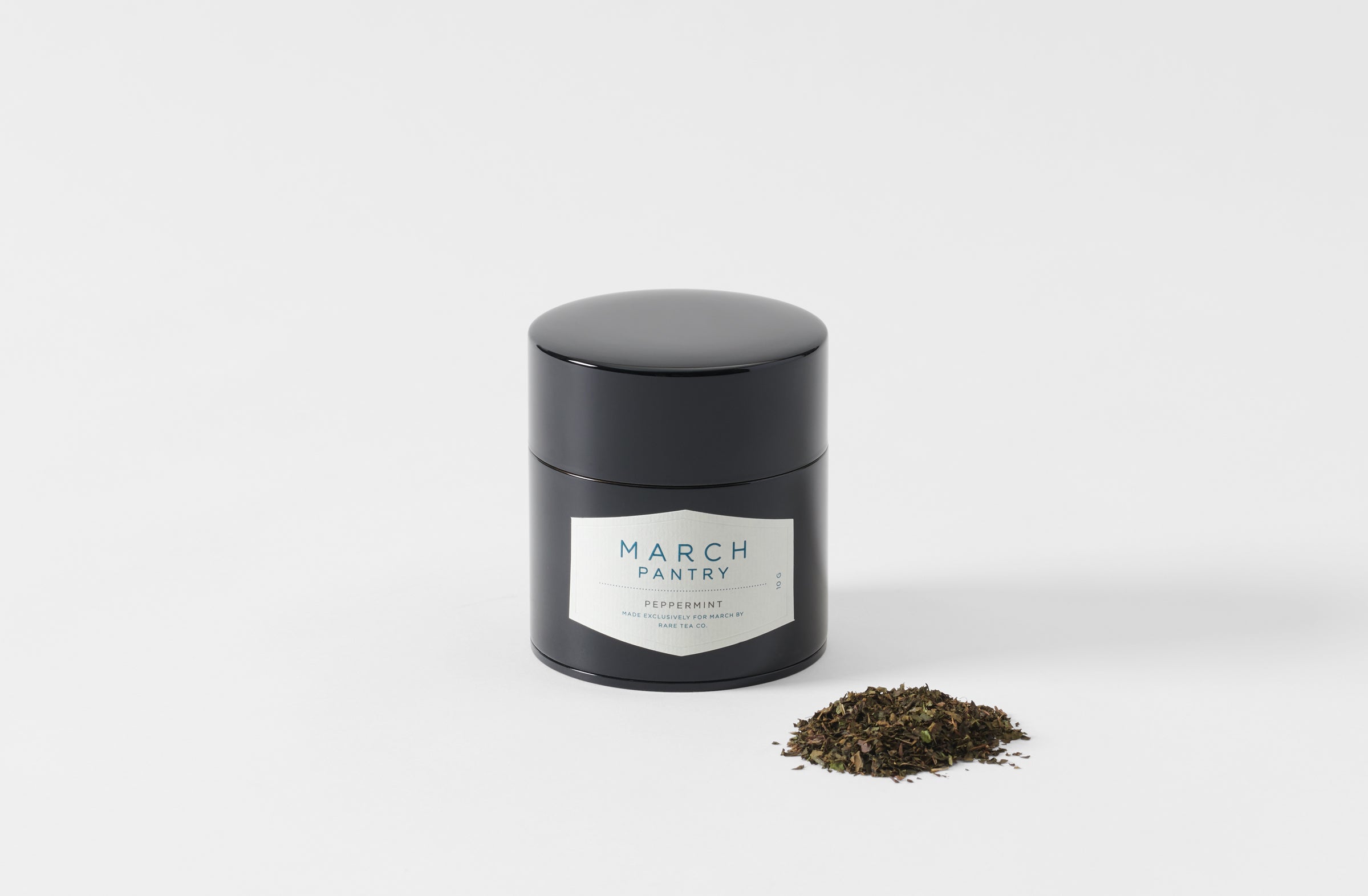 black tea can with peppermint tea on the side