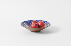 malaika hand painted ceramic matisse patterned serving bowl in blue and white on brown set with pomegranates