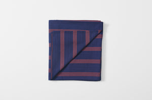 tensira navy and red stripe tablecloth shown folded with one corner turned up