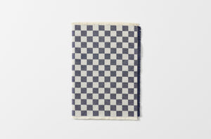 navy jacquard checkerboard runner with fringed edges shown folded