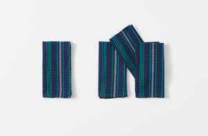 four tensira navy and green tartan napkins shown folded