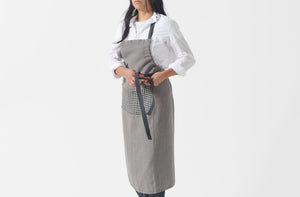 charcoal gingham apron being tied in front