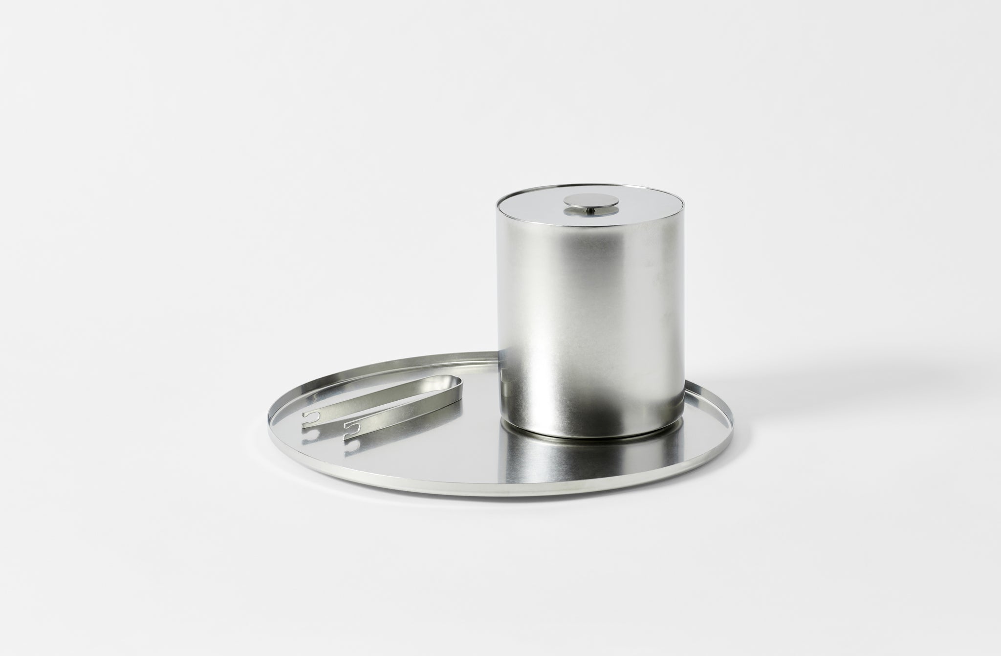 stile pewter steel round tray in a matte finish set with the matching ice bucket and ice tongs